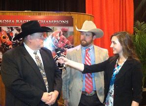 AQHA intern Annise Montplaisir interviews champion owners at the 2014 AQHA Racing Champions ceremony. Journal photo.