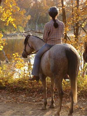 Annise and her horse Misty enjoy a trail ride. Photo by Annette Montplaisir